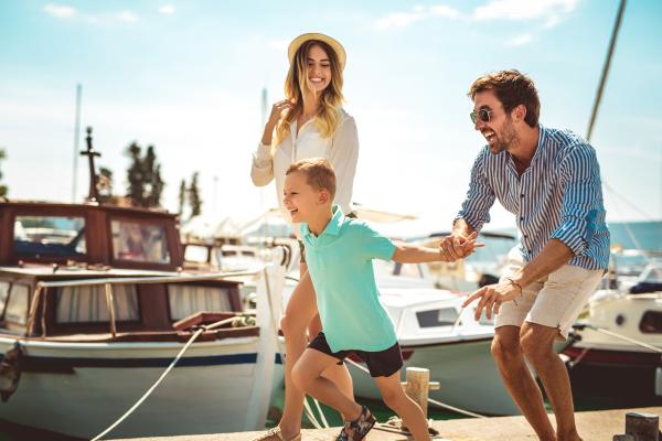 Family of three on the boat docks at Beacon Bay Marina